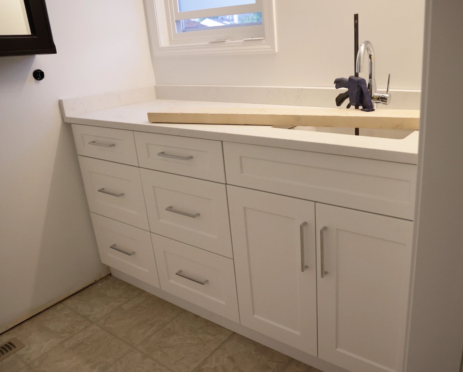 Custom bathroom vanity with countertop and faucet