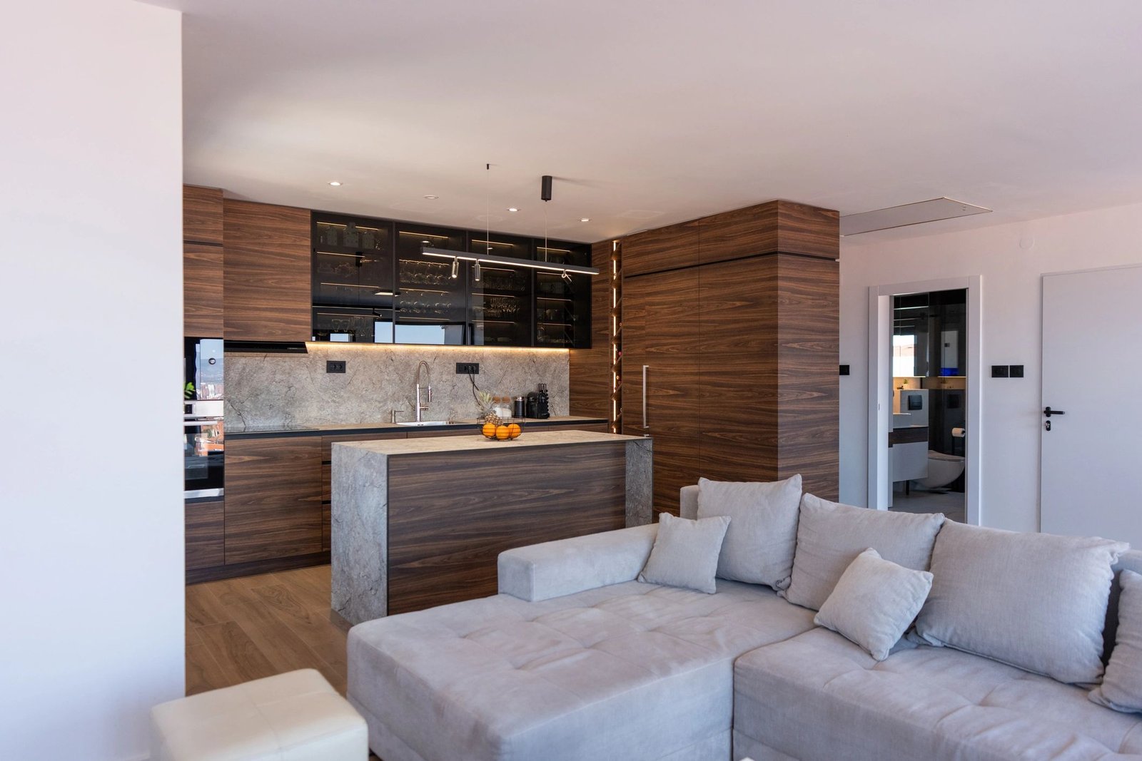 Walnut cabinetry and stone island in a refined modern interior